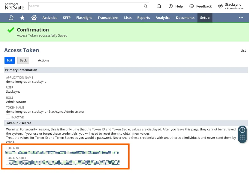 NetSuite Access Token confirmation page showing the Token ID and Token Secret values (blurred) highlighted for copying.