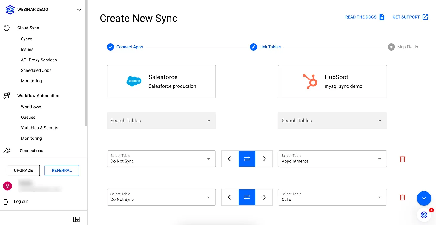 "Link Tables" step pairing Salesforce and HubSpot tables via "Select Table" dropdowns with sync direction arrows between them
