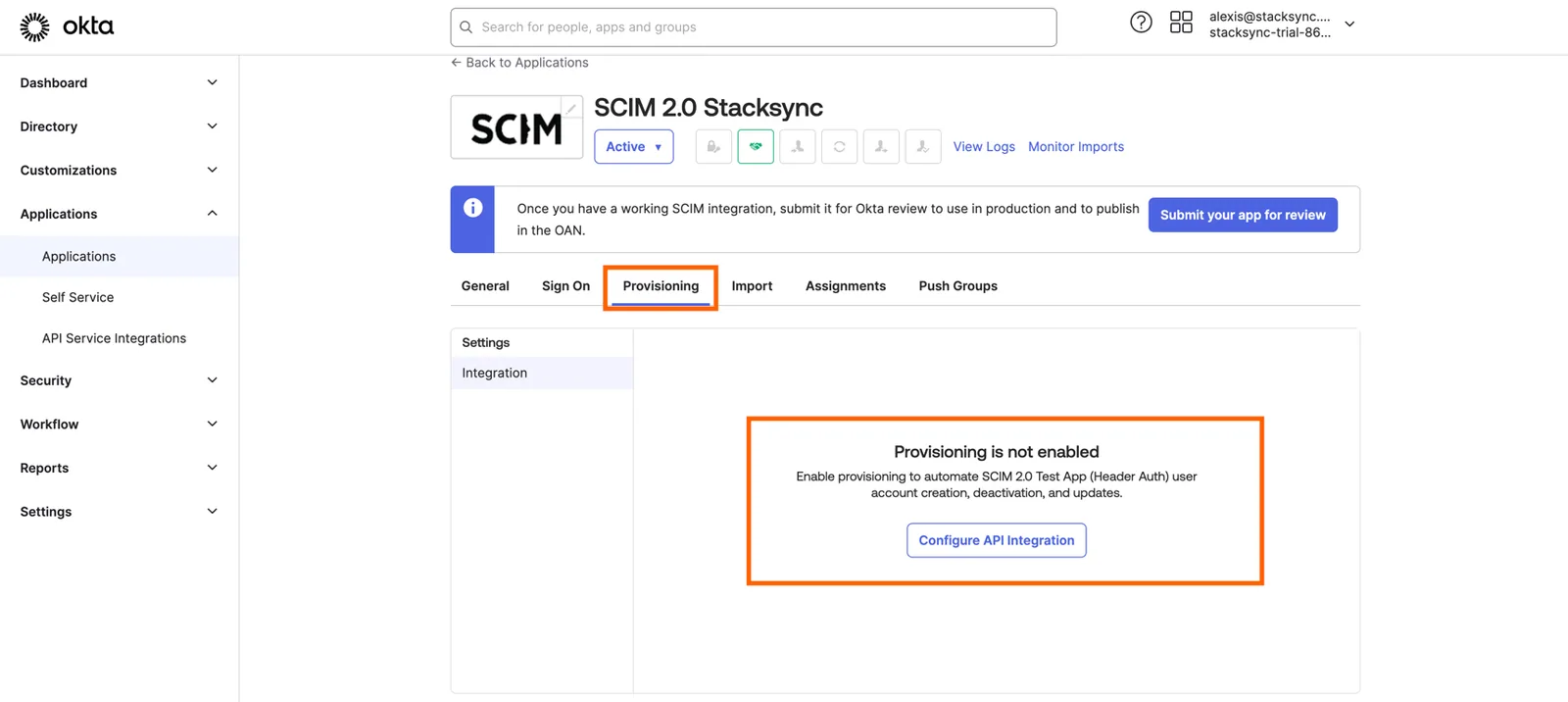 Okta SCIM 2.0 Stacksync app Provisioning tab showing "Provisioning is not enabled" with the "Configure API Integration" button highlighted.