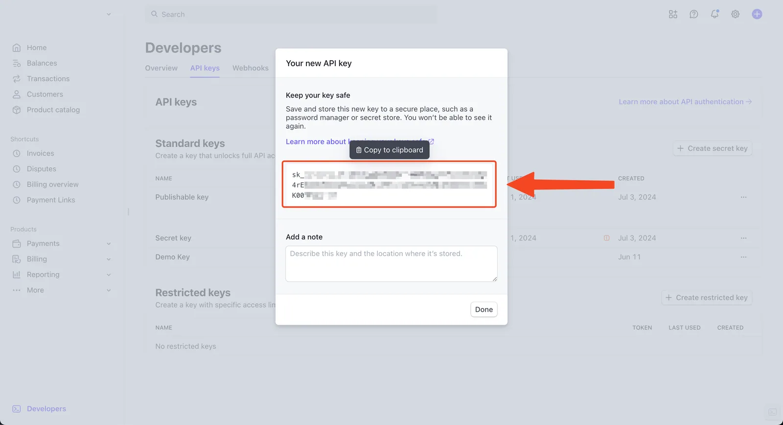 Stripe "Your new API key" dialog with the redacted secret key and a "Copy to clipboard" tooltip highlighted